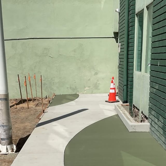 Green colored concrete walkway poured alongside a building at the Venice Family Clinic.